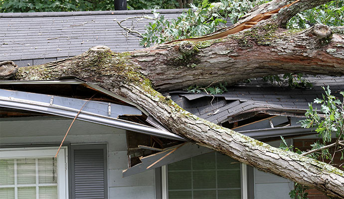 home roof and gutters are damaged by hurricane